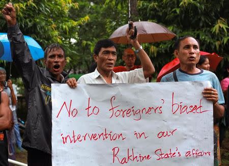 Protesters holds up a placard as they shout slogans during a rally against former U.N. chief Kofi Annan in Sittwe, Myanmar, September 6, 2016. REUTERS/Wa Lone