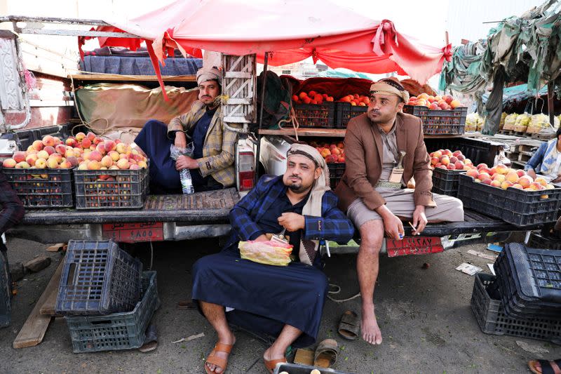 Fruit vendors chew qat, a mild stimulant, amid concerns of the spread of the coronavirus disease (COVID-19) at a fruit market in Sanaa