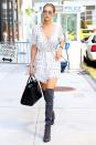 <p>The model spent Labor Day in Manhattan wearing a windowpane-checked romper with gray over-the-knee boots from Stuart Weitzman and black crocodile leather bag by Saint Laurent.</p>