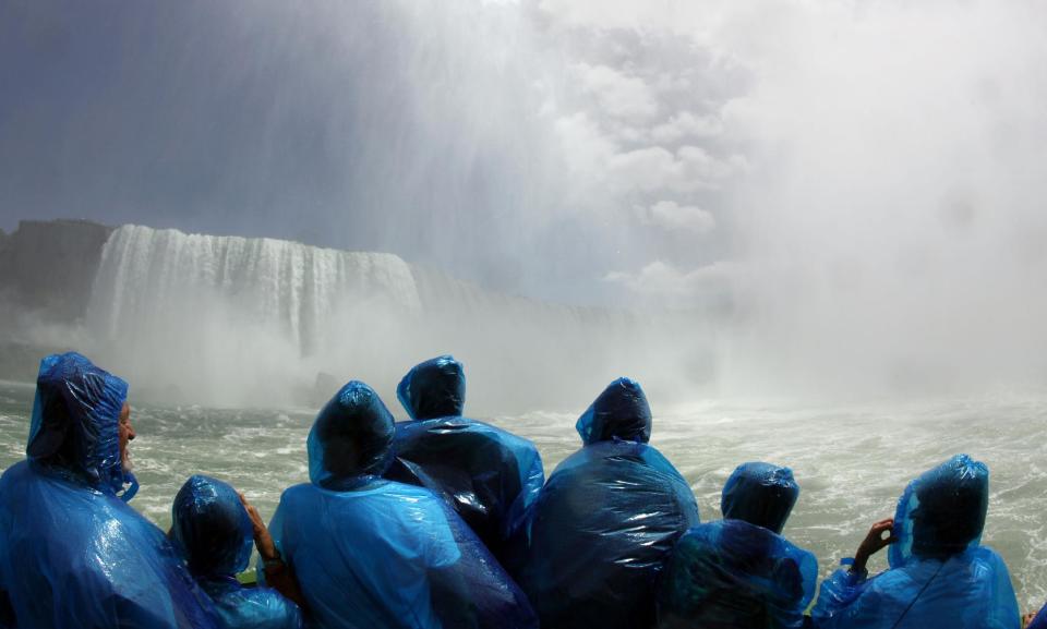 FILE - In this June 11, 2010 file photo, tourists ride the Maid of the Mist boat at the base of the Horseshoe Falls in Niagara Falls, N.Y. The tour company chosen to take over the Niagara Falls tour boat business in Canada says it plans to build customized new boats and upgrade amenities while maintaining the things that have made the sightseeing rides so popular for more than 100 years. (AP Photo/David Duprey, File)