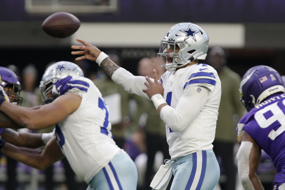 Dallas Cowboys quarterback Dak Prescott throws a pass during the first half of an NFL football game against the Minnesota Vikings, Sunday, Nov. 20, 2022, in Minneapolis. (AP Photo/Andy Clayton-King)