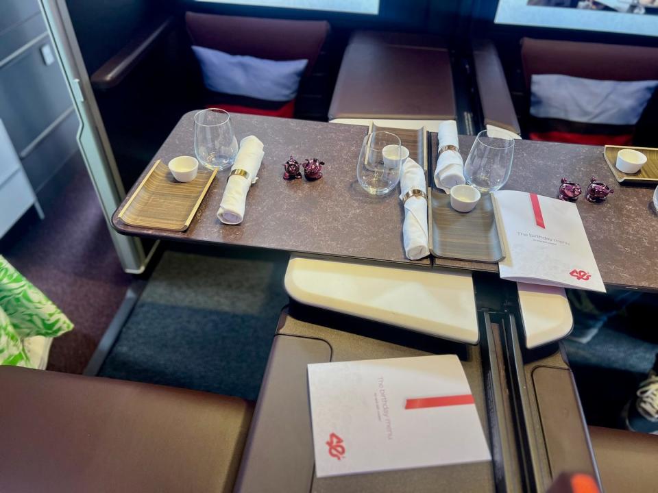 Virgin's Retreat Suite table set up for dining with glassware and a menu