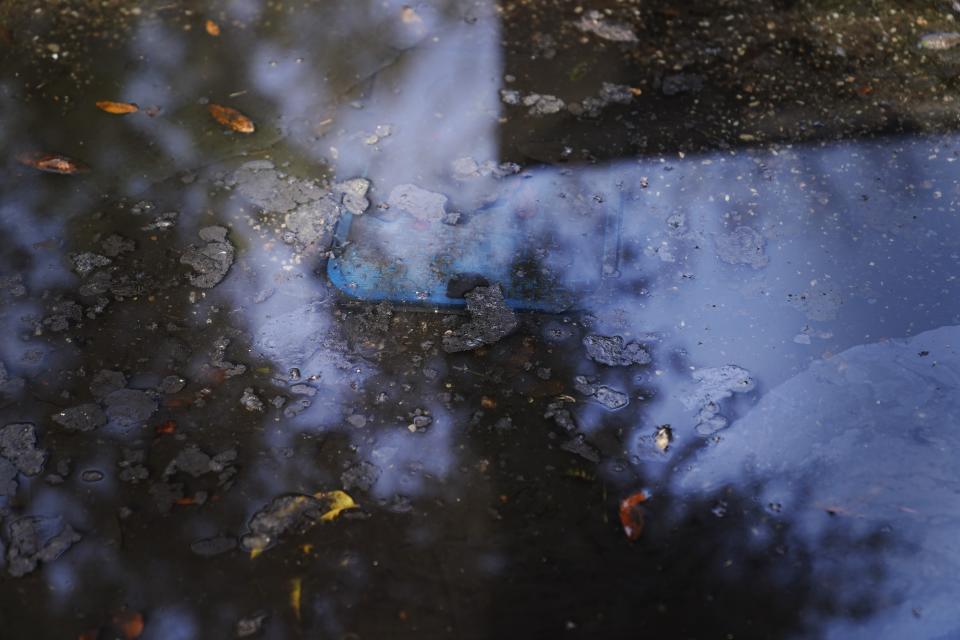 Debris and water floods a street on Thursday, Dec. 7, 2023, in Prichard, Ala. The city loses 60% of its drinking water from an aging distribution system. Communities nationwide lose trillions of gallons. (AP Photo/Brynn Anderson)