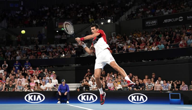 Novak Djokovic of Serbia returns during his singles match against Kevin Anderson of South Africa on day 2 of the ATP Cup tennis tournament at Pat Rafter Arena in Brisbane