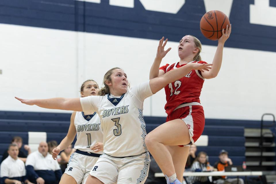 Crestwood’s Rebecca Brady goes up for a shot while Rootstown’s Abby White defends during a basketball game Tuesday, Nov. 28 in Rootstown.