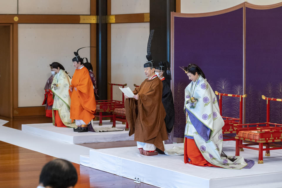 In this photo provided by the Imperial Household Agency of Japan, Japan's Crown Prince Akishino, in orange robe, flanked by his wife Crown Princess Kiko, second from left, attends a ceremony for formally proclaims Akishino is the first in line to the Chrysanthemum Throne, with Emperor Naruhito, second from right, and Empress Masako, right, at the Imperial Palace in Tokyo, Sunday, Nov. 8, 2020. Akishisho, Naruhito's younger brother, was formally sworn in as first in line to the Chrysanthemum Throne in a traditional palace ritual that has been postponed for seven month and scaled down due to the coronavirus pandemic. (Imperial Household Agency of Japan via AP)