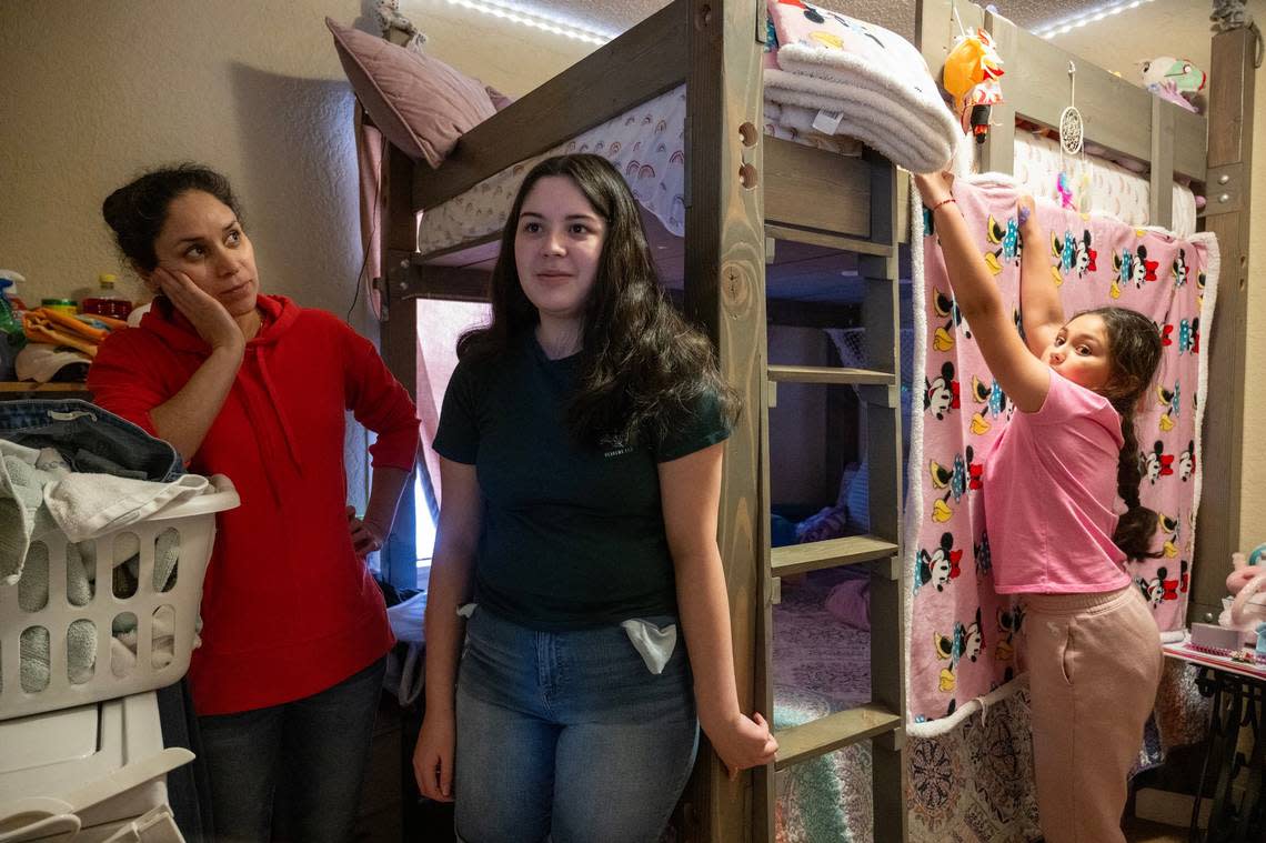 Adelaida Romero-Carlos, 41, talks with her daughter Matilda, 13, and Abigail, 8, in the bedroom the girls share at their home at Clearview Village on Monday, March 24, 2024, in De Soto, Kansas.