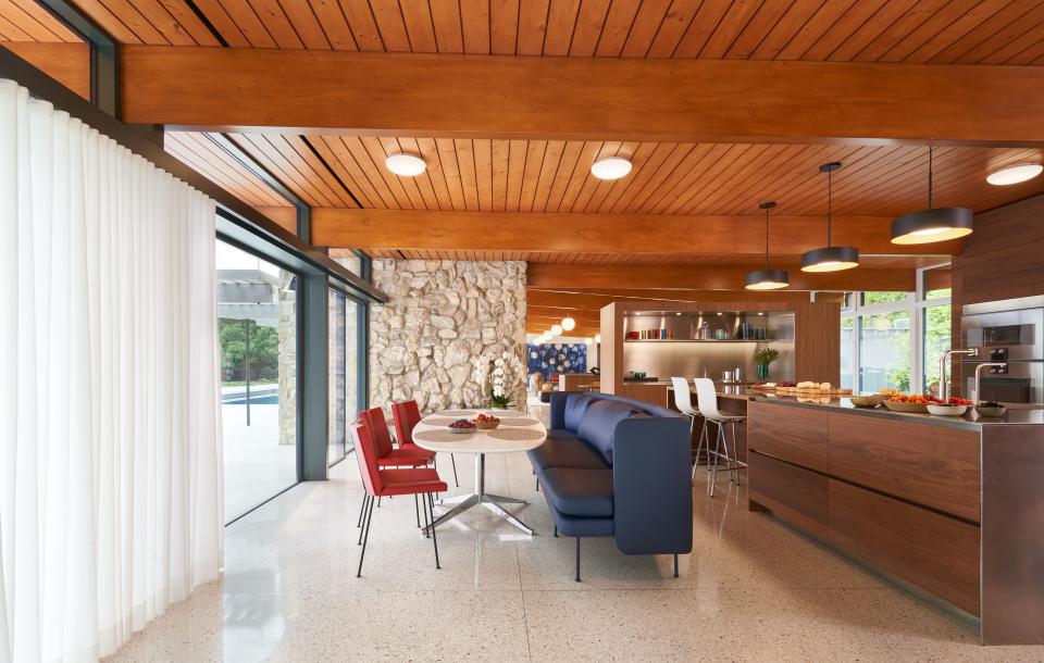The kitchen layout was completely reimagined as part of the renovation. The more casual dining area features custom chairs made by The Furniture Shop, a Blu Dot banquette sofa, a custom tabletop, and Knoll base.