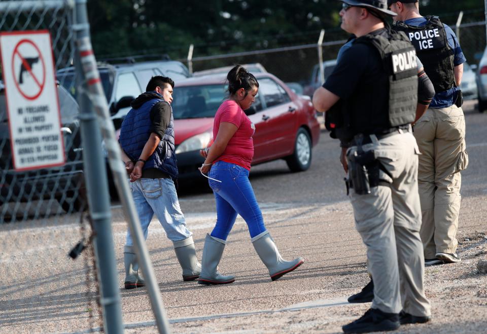 Two people are taken into custody at a Koch Foods Inc. plant in Morton, Mississippi on Aug. 7, 2019.