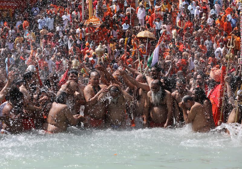 FILE PHOTO: Sadhus take a dip in the Ganges river during "Kumbh Mela", or the Pitcher Festival, in Haridwar