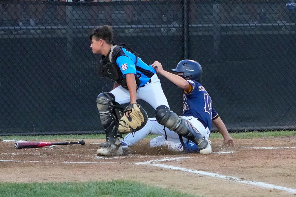 Aug 12, 2022; Bristol, CT, USA; Toms River East catcher Ryan McHugh (25) misses a throw allowing New York right fielder Mikey Castellano (14) to score a run during the second inning at A. Bartlett Giamatti Little League Leadership Training Center. Mandatory Credit: Gregory Fisher-USA TODAY Sports