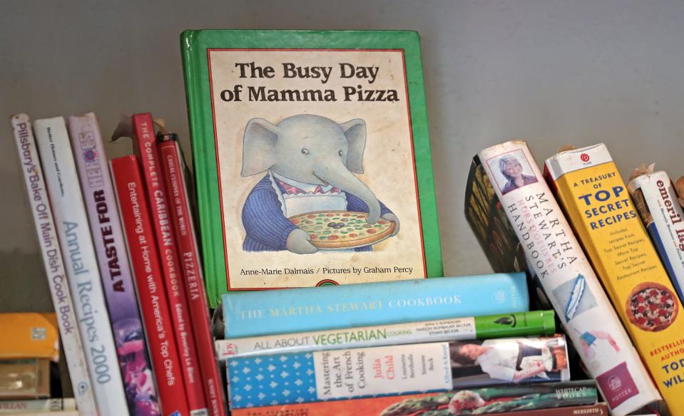 "The Busy Day of Mamma Pizza" a children's book that Niki Thomas-Zimmerman gifted her grandmother Betty, stands atop a pile of cookbooks above the register at Tomaso's Italian Villa in Norton.