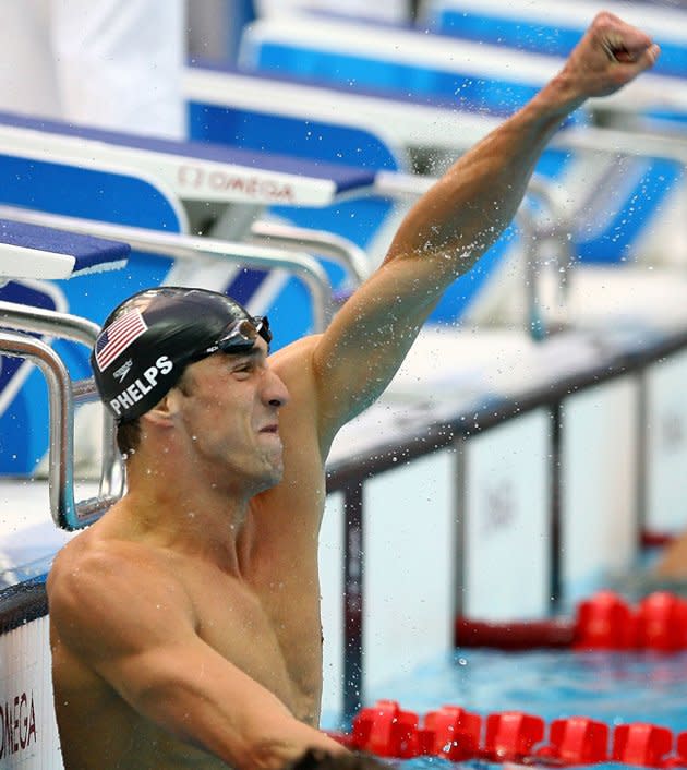 Michael Phelps of the United States celebrates victory in the Men's 100m Butterfly Final held at the National Aquatics Centre during Day 8 of the Beijing 2008 Olympic Games on August 16, 2008 in Beijing, China. By winning gold in the Men's 100m Butterfly Phelps tied Mark Spitz's record of winning seven gold medals in a single Olympic Games. (Getty Images)