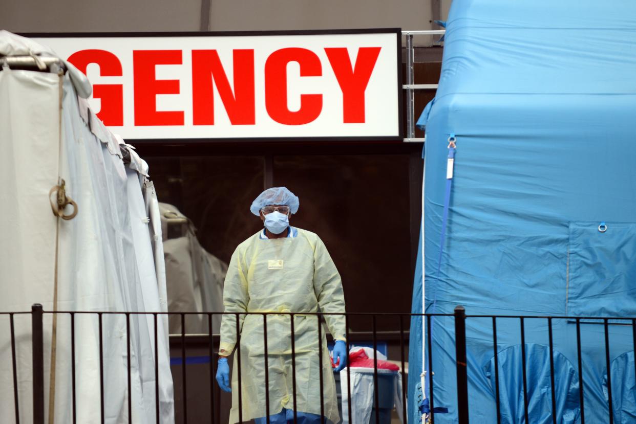 A doctor stands in the middle of the makeshift COVID-19 screening center outside Elmhurst Hospital in Queens, New York.  (NurPhoto via Getty Images)