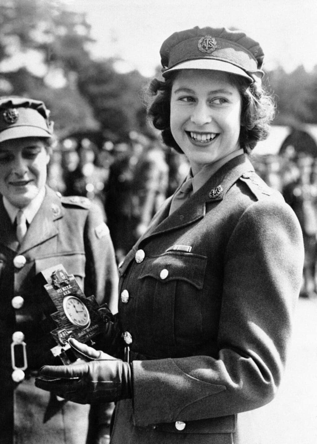 Britain’s Princess Elizabeth, a Junior Commander in the Auxiliary Territorial Service, receives a clock presented to her by her old associates at the camp where she received her early training, during a ceremony at the No. 1 M.T. Training Center, in Camberley, England, Aug. 3, 1945. Queen Elizabeth II, Britain’s longest-reigning monarch and a rock of stability across much of a turbulent century, has died. She was 96. Buckingham Palace made the announcement in a statement on Thursday Sept. 8, 2022. (AP Photo, File)