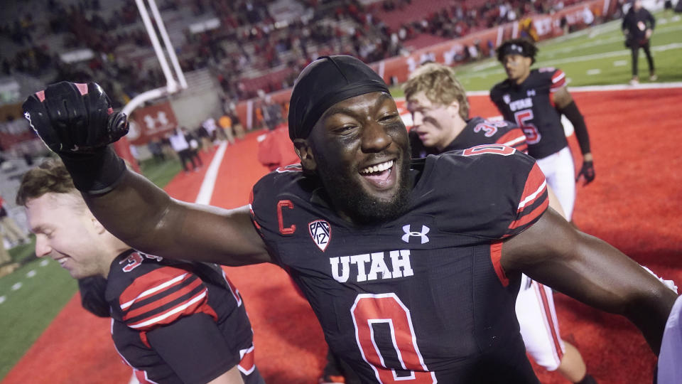 FILE - Utah linebacker Devin Lloyd (0) celebrates as he walks off the field following their NCAA college football game against Arizona State in Salt Lake City, in this Saturday, Oct. 16, 2021, file photo. Lloyd was selected to The Associated Press Midseason All-America team, announced Tuesday, Oct. 19, 2021. (AP Photo/Rick Bowmer, File)