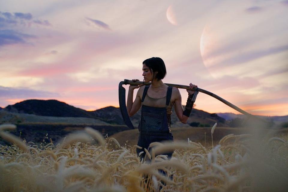 Sofia Boutella holds a scythe