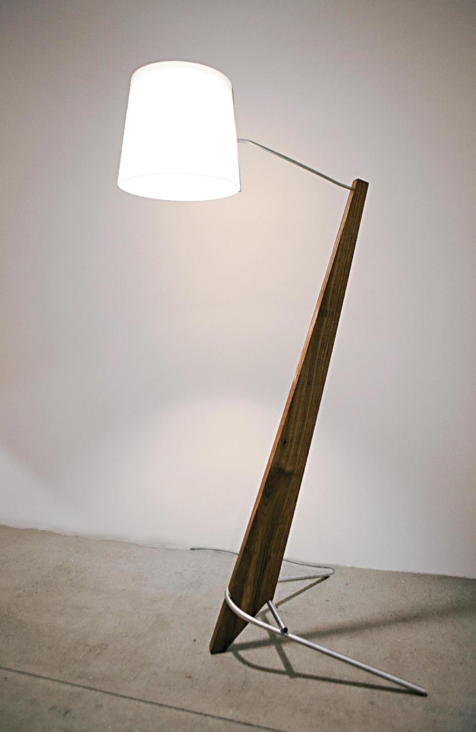 This publicity photo provided by Cerno LLC shows a 84” tall Silva Giant lamp crafted from aluminum and walnut, a dramatic yet sleek fixture that epitomizes contemporary design from Laguna Beach, CA-based Cerno. Silva Giant Designers are experimenting with scale for many of this fall’s furniture and accessories (www.cernogroup.com). (AP Photo/Cerno LLC, David Tosti)