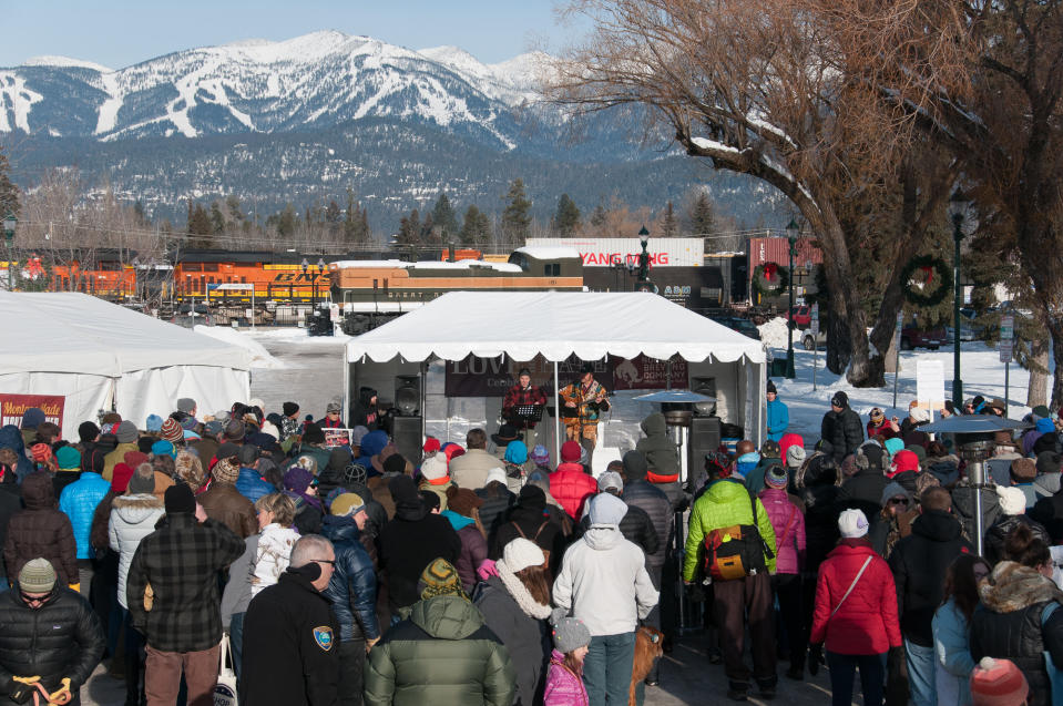 The crowd watching Montana musician Jack Gladstone on the stage at the Love Not Hate gathering in Whitefish, MT, with Whitefish Mountain ski resort in the distance. (Photo: Lauren Grabelle)