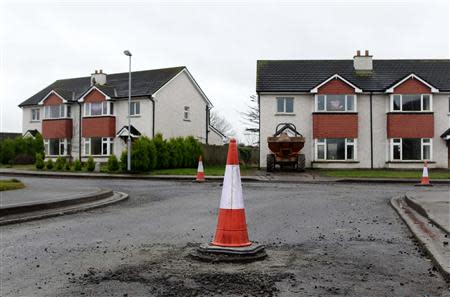 A traffic cone marks a raised manhole cover on the Glenall housing estate in the village of Borris-in-Ossory, County Laois, Ireland February 13, 2013. REUTERS/Cathal McNaughton