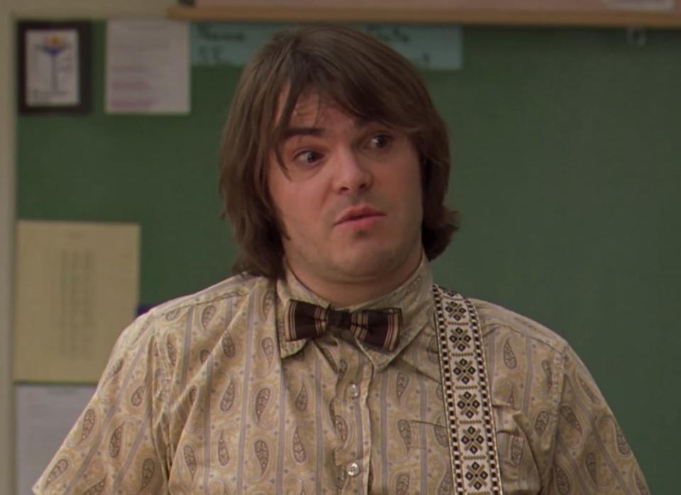 Jack Black with a guitar strap and bowtie.
