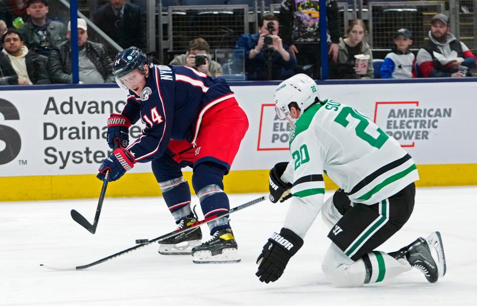 Dec 19, 2022; Columbus, Ohio, USA; Columbus Blue Jackets left wing Gustav Nyquist (14) makes a pass over the stick of Dallas Stars defenseman Ryan Suter (20) during the third period of their NHL game at Nationwide Arena.