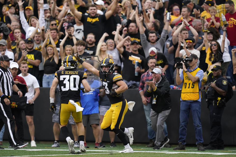 Iowa defensive back Cooper DeJean (3) celebrates with teammate defensive back Quinn Schulte (30) after intercepting a pass during the first half of an NCAA college football game against Iowa State, Saturday, Sept. 10, 2022, in Iowa City, Iowa. (AP Photo/Charlie Neibergall)