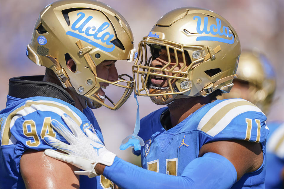 UCLA defensive lineman Gabriel Murphy, right, celebrates with defensive lineman Dovid Magna after sacking Washington State quarterback Cameron Ward during the second half of an NCAA college football game, Saturday, Oct. 7, 2023, in Pasadena, Calif. (AP Photo/Ryan Sun)