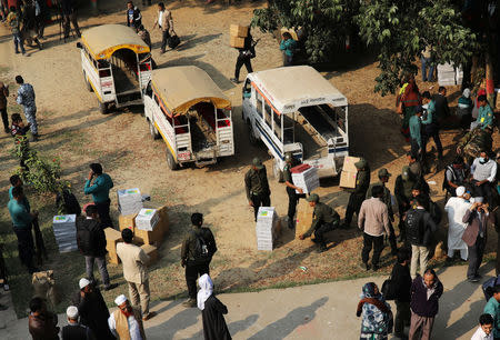 Law enforcement officials gather to distribute electronic voting materials to a different voting centre ahead of 11th general election which will be held on December 30 in Dhaka, Bangladesh, December 29, 2018. REUTERS/Mohammad Ponir Hossain