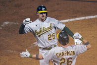 Oakland Athletics' Stephen Piscotty, top, celebrates his two-run home run off Minnesota Twins pitcher Matt Shoemaker with Matt Chapman during the sixth inning of a baseball game Friday, May 14, 2021, in Minneapolis. (AP Photo/Jim Mone)