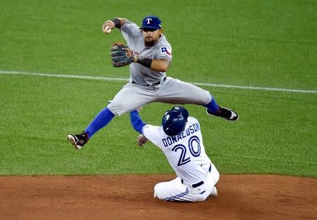 Oct 8, 2015; Toronto, Ontario, CAN; Texas Rangers second baseman Rougned Odor (top) forces out Toronto Blue Jays third baseman Josh Donaldson (20) on a fielder's choice in the fourth inning in game one of the ALDS at Rogers Centre. Mandatory Credit: Dan Hamilton-USA TODAY Sports