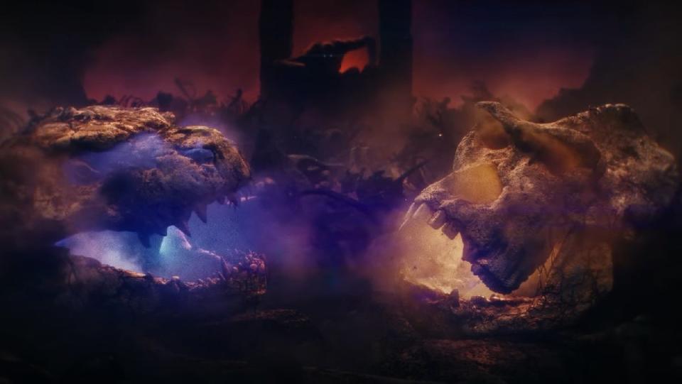 The skulls of Godzilla and Kong rest in the foreground as a new, unseen threat looms in the background of the teaser for Godzilla x Kong: The New Empire.