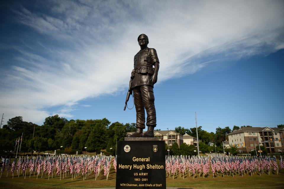 Volunteers help set up the Field of Honor at the Airborne & Special Operations Museum on Friday, Sept. 10, 2021. Over 500 American flags were put into place and each with a sponsor’s name and the name of the person the flag is in honor of. The flags will be on display until Nov. 14.