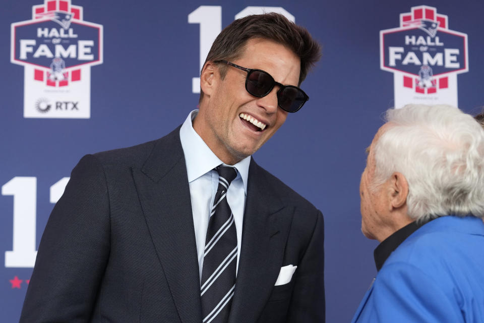 Former New England Patriots quarterback Tom Brady, left, speaks with Patriots owner Robert Kraft as they arrive for the Patriots Hall of Fame induction ceremony for Brady at Gillette Stadium, Wednesday, June 12, 2024, in Foxborough, Mass. (AP Photo/Steven Senne)