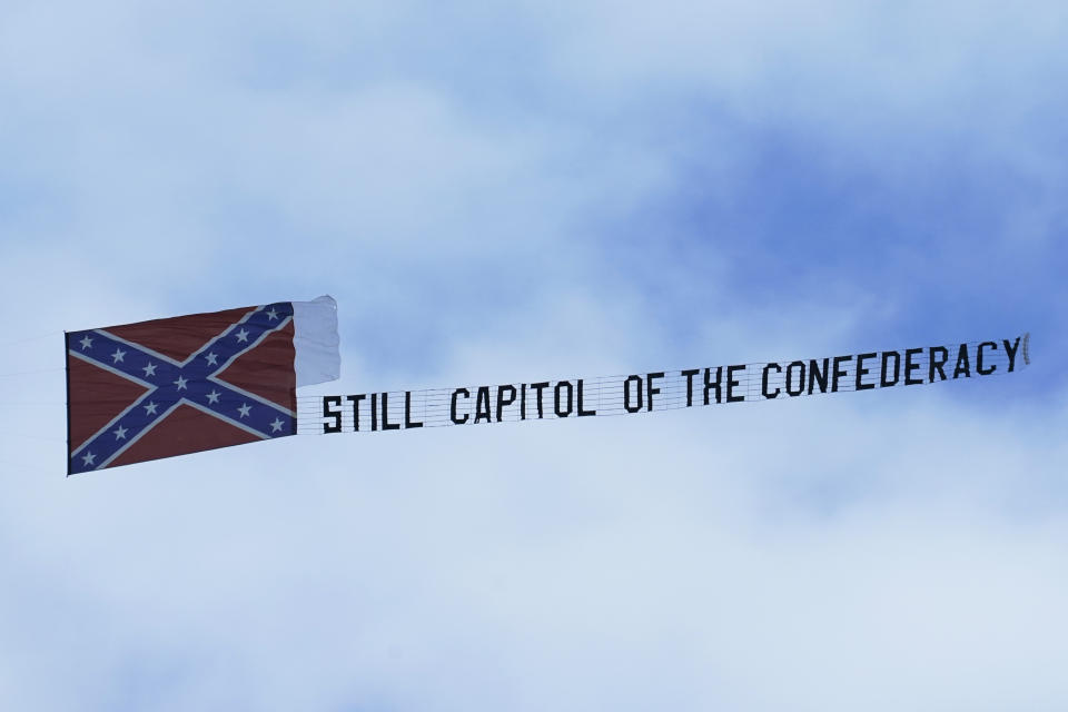 A small plane carries a banner declaring "Still Capitol of the Confederacy" as it flies around a NASCAR Xfinity Series auto race Saturday, Sept. 12, 2020, in Richmond, Va. (AP Photo/Steve Helber)