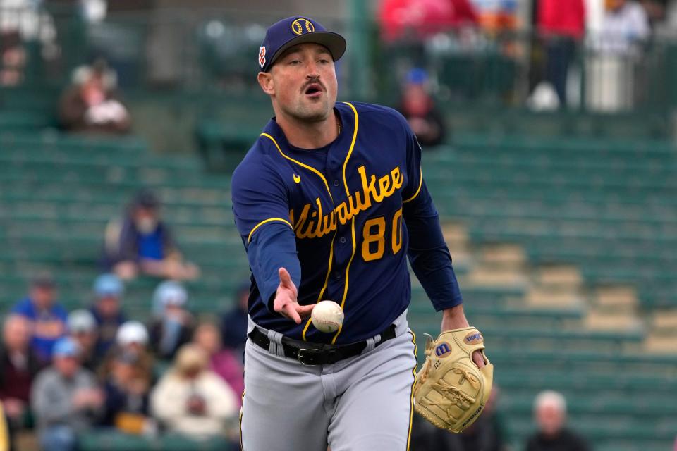 Milwaukee Brewers pitcher James Meeker (80) flips the ball for an out against the Los Angeles Angels in the first inning at Tempe Diablo Stadium.