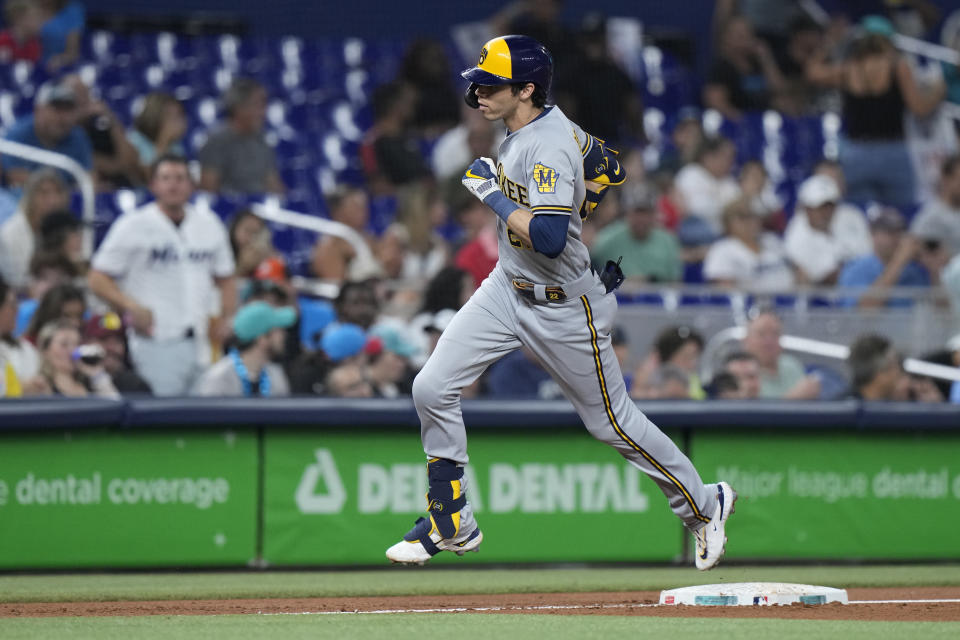 Milwaukee Brewers' Christian Yelich rounds third base as he heads home after hitting a home run scoring Blake Perkins, during the second inning of a baseball game against the Miami Marlins, Friday, Sept. 22, 2023, in Miami. (AP Photo/Wilfredo Lee)