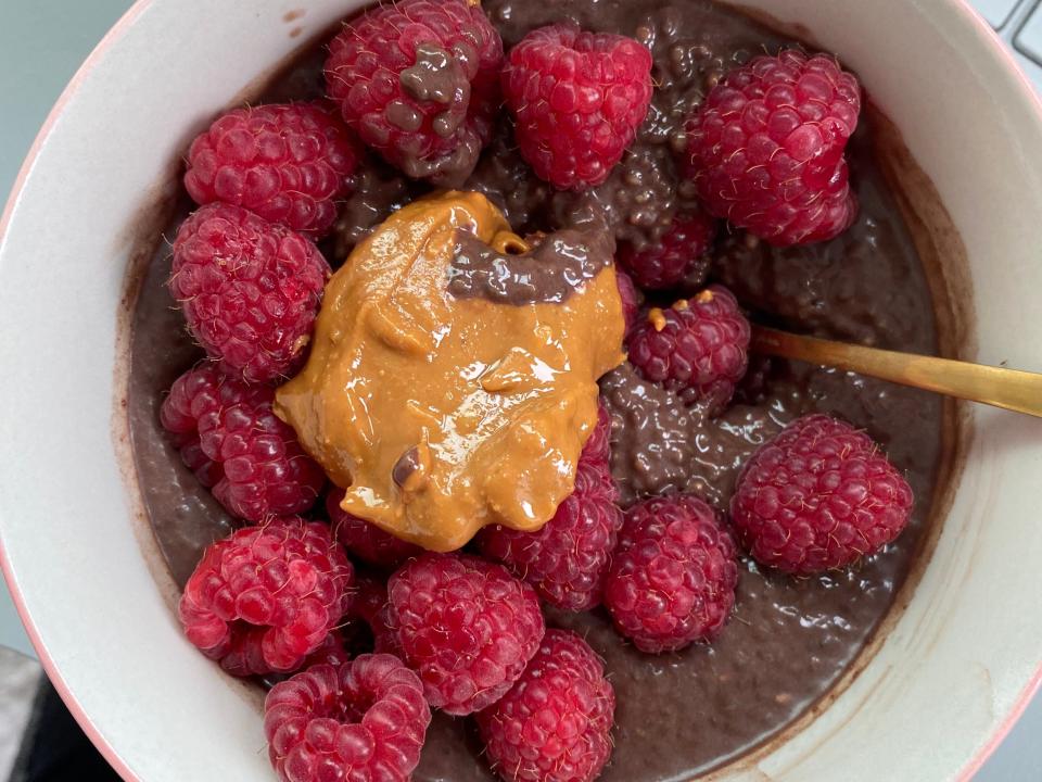 Chocolate protein chia pudding with raspberries and peanut butter.