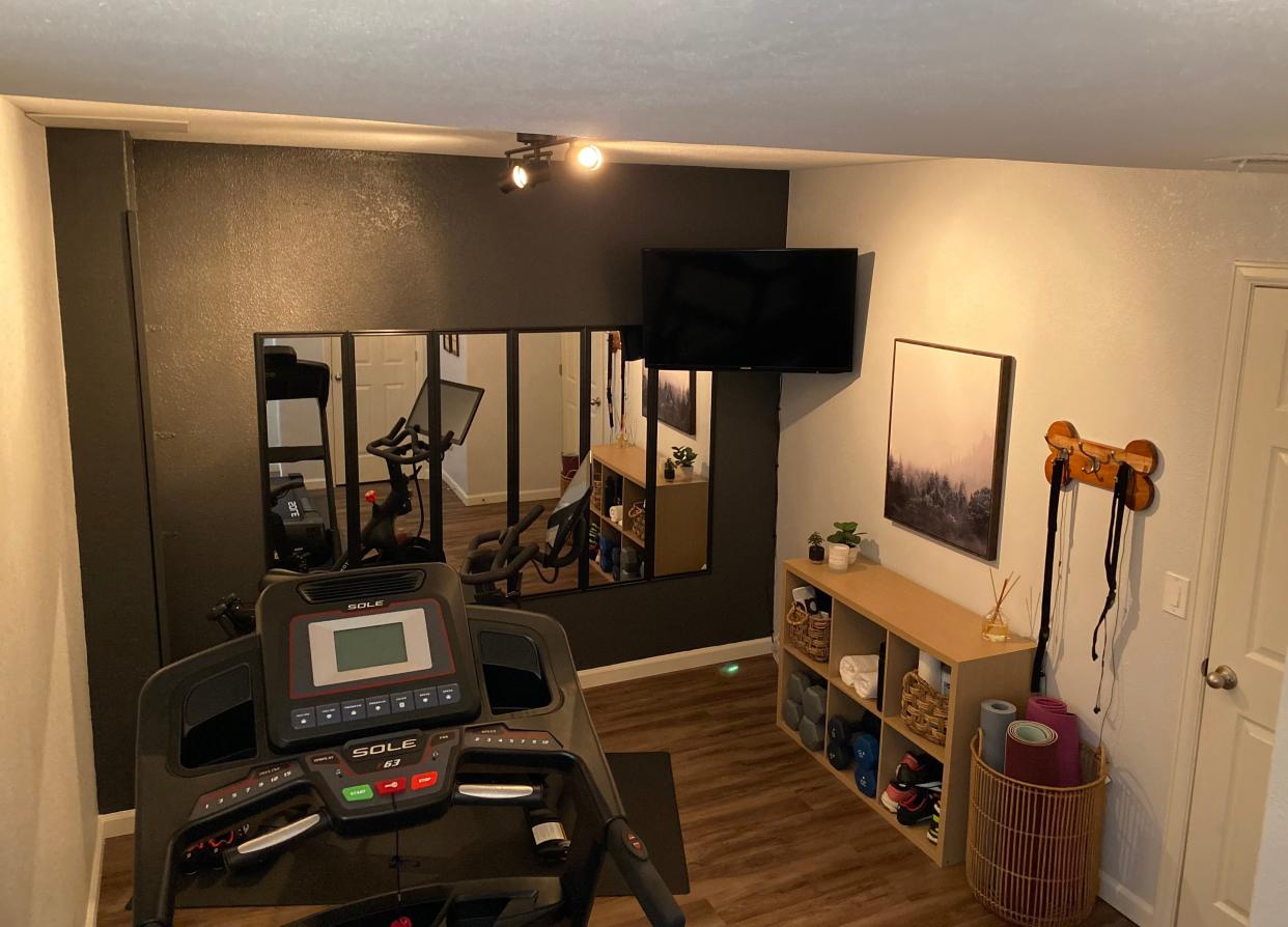 Mirror, mirror: Rather than spend dearly on having a custom mirrored wall installed in their home gym, Paige and Adam bought six 12-inch by 48-inch vertical mirrors from Target for $11 each, and hung them side by side on the accent wall.