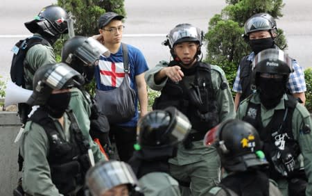 Riot police officers patrol Wong Tai Sin district during an anti-government protests in Hong Kong