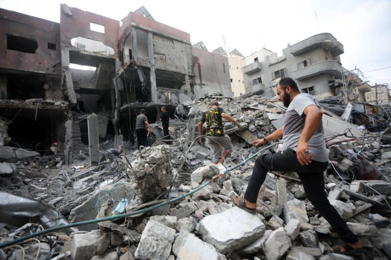 Palestinians inspect the destruction following Israeli airstrikes on Khan Younis, southern Gaza Strip on Tuesday. Photo by Ismael Mohamad/UPI