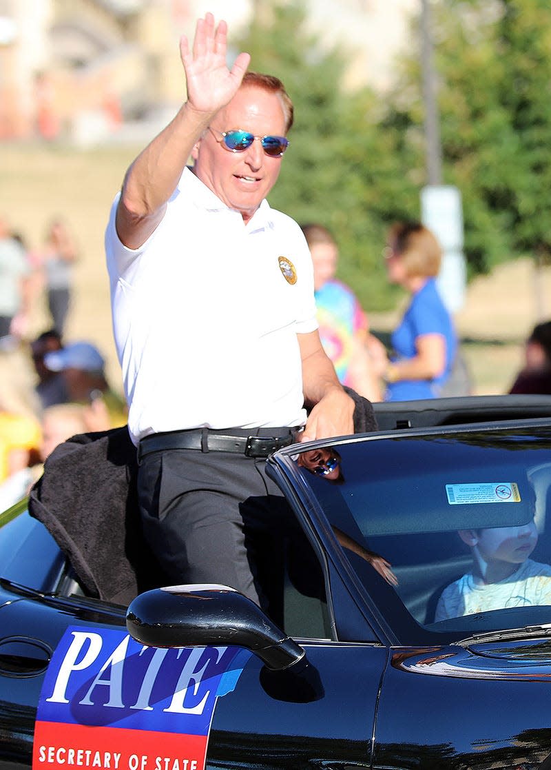 Iowa Secretary of State Paul Pate waves during the 2022 Iowa State Fair Parade as spectators watch the state’s largest parade with an estimated 200 floats, dignitaries, marching bands, vehicles, and performing units as it travels west from the State Capitol Complex along East Grand Avenue to 15th Street in Des Moines.  