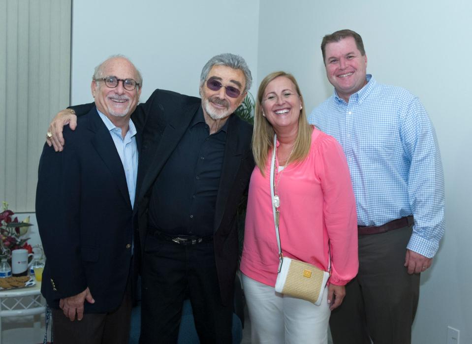 Bob Sherman, left, joins Burt Reynolds, Kate and Stephen Rubenacker at Rosarian Academy on Saturday, Oct. 15, 2016, before a showing of the 1978 film 'Hooper.' Sherman is retiring after 24 years at Rosarian, finishing his career with a production of 'Legally Blonde JR.'