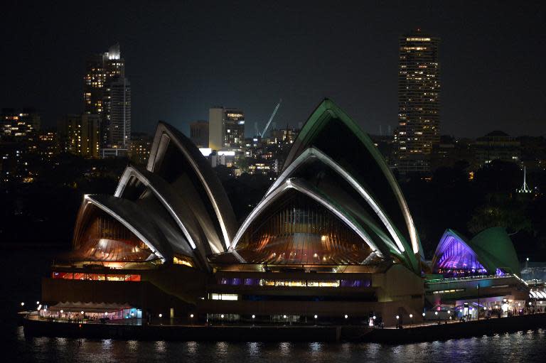 A view of Australia's iconic landmark Sydney Opera House during the annual Earth Hour on March 23, 2013, one minute brightly lit, the next plunged into darkness