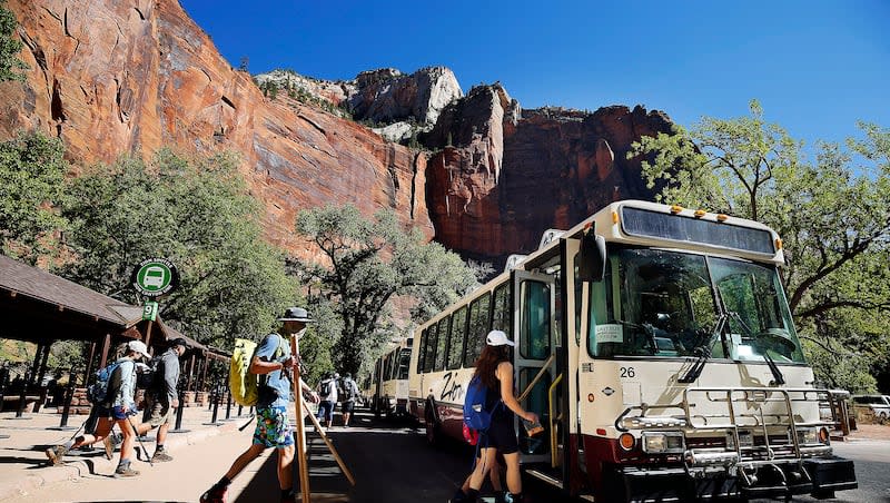 Visitors board a shuttle at Zion National Park on Oct. 14, 2020.