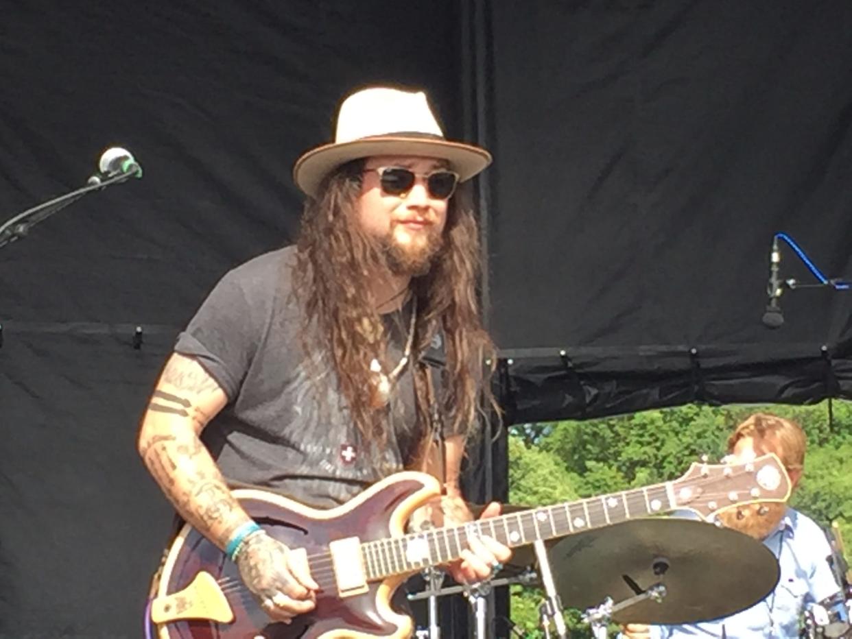 Twiddle front man Mihali Savoulidis, shown performing in 2017 at the Vermont-born jam band's Tumble Down festival in Burlington.