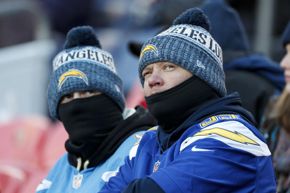 Los Angeles Chargers fans watch during the first half of an NFL football game against the Denver Broncos Sunday, Dec. 1, 2019, in Denver. (AP Photo/David Zalubowski)