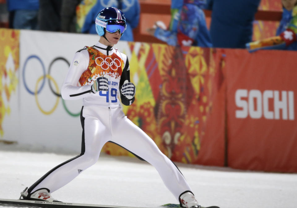 Slovenia's Peter Prevc clenches his fists after his first attempt during the men's normal hill ski jumping final at the 2014 Winter Olympics, Sunday, Feb. 9, 2014, in Krasnaya Polyana, Russia. (AP Photo/Gregorio Borgia)