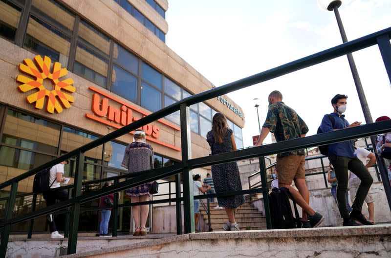 FILE PHOTO: People queue to get tested, amid the coronavirus disease (COVID-19) outbreak, in Madrid