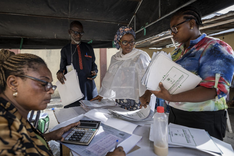 Electoral workers collate results manually at a center in Lagos, Nigeria Sunday, Feb. 26, 2023. People were still voting across Nigeria Sunday morning, the day after Africa's most populous nation was supposed to have completed elections, as logistical and security challenges caused widespread delays. (AP Photo/Ben Curtis)